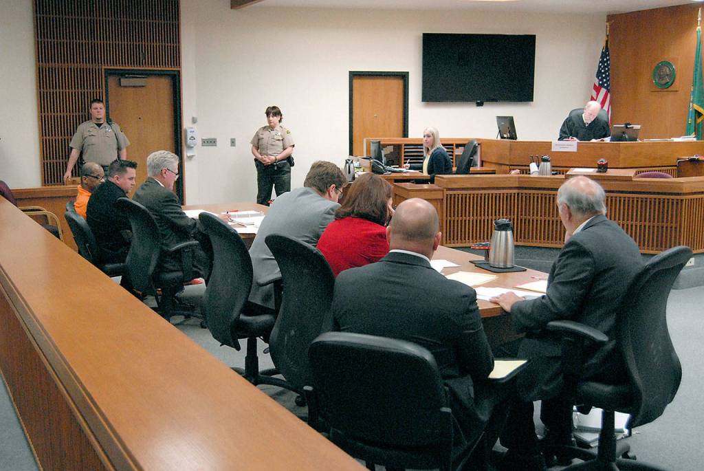 Defense attorneys and a team from the Clallam County Prosecutors Office convene before Superior Court Judge Brian Coughenour on Tuesday in Port Angeles. (Keith Thorpe/Peninsula Daily News)