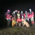 Clallam County Sheriffs Office Search and Rescue Team members stand with a 70-pound dog they rescued from a bluff west of Port Angeles on Wednesday. (Clallam County Sheriffs Office)