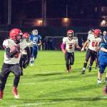 Steve Mullensky/for Peninsula Daily News The Redhawk offense clears a path for Cole Crawford to gain yardage for a first down during a game against Chimacum on Friday in Memorial Field.