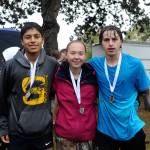Lonnie Archibald/for Peninsula Daily News                                Three Forks cross-country runners, from left Wesley Camacho, Madelyn Archibald and Colton Duncan, all qualified at district at Woodland on Thursday for the state 1A cross-country meet to be held Saturday.