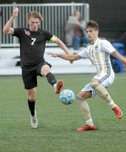 <strong>Keith Thorpe</strong>/Peninsula Daily News                                Pierces Austin Stafford, left, and Peninsulas Manuyel Galiano dance around a loose ball during Wednesdays NWAC first-round playoff game at Wally Sigmar Field in Port Angeles.