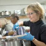 Jody Vodder, right, serves dinner to clients at the Jefferson County Winter Shelter in Port Townsend. (Jesse Major/Peninsula Daily News)