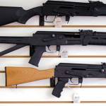 Semi-automatic rifles are displayed on a wall at a gun shop in Lynnwood. Voters will decide the fate of I-1639 in the Nov. 6 election. (The Associated Press)