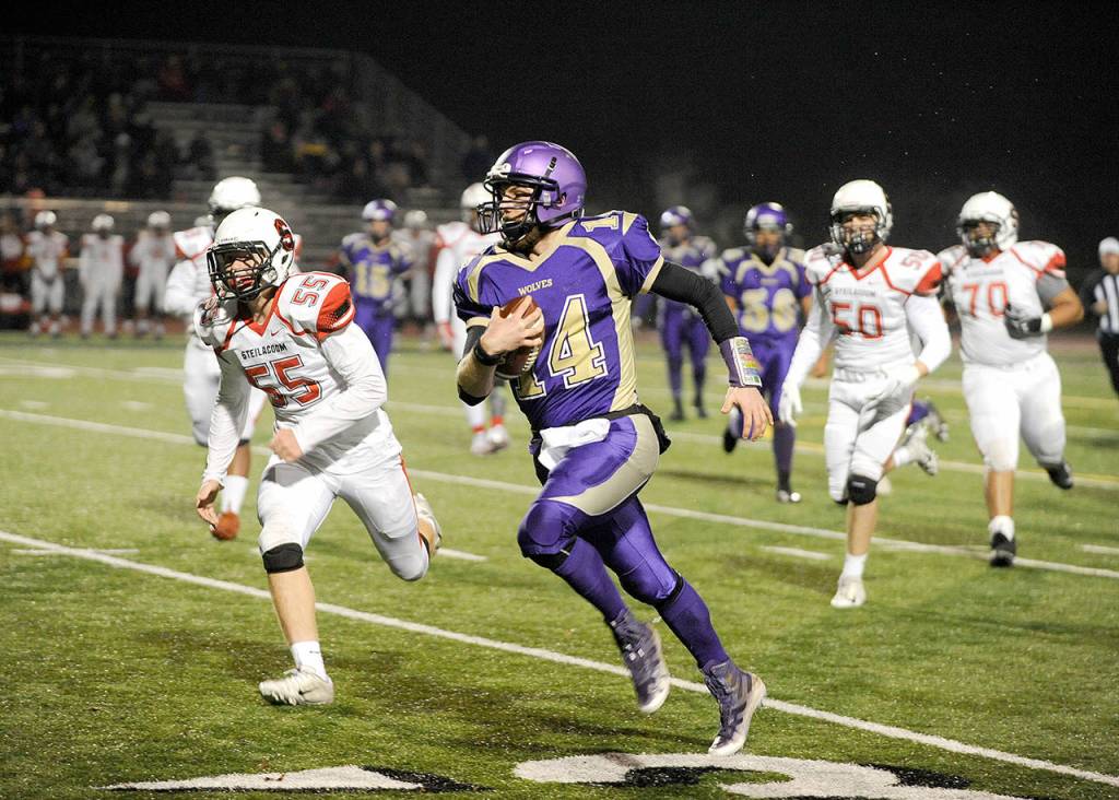Michael Dashiell/Olympic Peninsula News Group Sequim quarterback Riley Cowan runs for a first down in the opening quarter of the Wolves 49-12 Class 2A state tournament loss to Steilacoom on Friday.