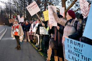 City Councilmember and rally co-organizer Michelle Sandoval encourages a crowd estimated to be around 300 to chant “protect Mueller” and “nobody’s above the law” during a protest Thursday at 5 pm along Sims Way. Rallies like this one were planned across the peninsula. (Jeannie McMacken/ Peninsula Daily News)