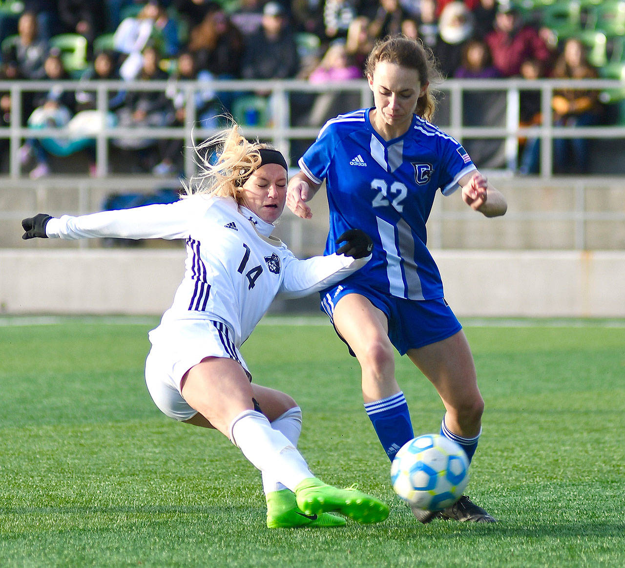 Peninsula Taylor Graham battles for a loose ball with Clarks Julie Williams in the NWAC championship match in Tukwila Sunday. The Peninsula women won 2-0 to win the NWAC championship. (Jay Cline)