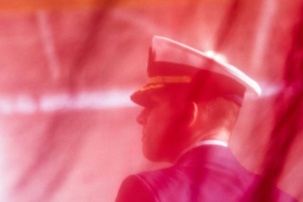 U.S. Coast Guard Cmdr. Hans Govertsen, executive Officer of U.S. Coast Guard Air Station/Sector Field Office Port Angeles, watches on during the Veterans Day ceremony at the Coast Guard base Sunday. (Jesse Major/Peninsula Daily News)
