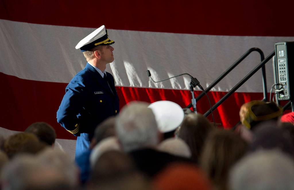 U.S. Coast Guard Cmdr. Hans Govertsen, executive officer of U.S. Coast Guard Air Station/Sector Field Office Port Angeles, watches on during the Veterans Day ceremony at the Coast Guard base Sunday. (Jesse Major/Peninsula Daily News)