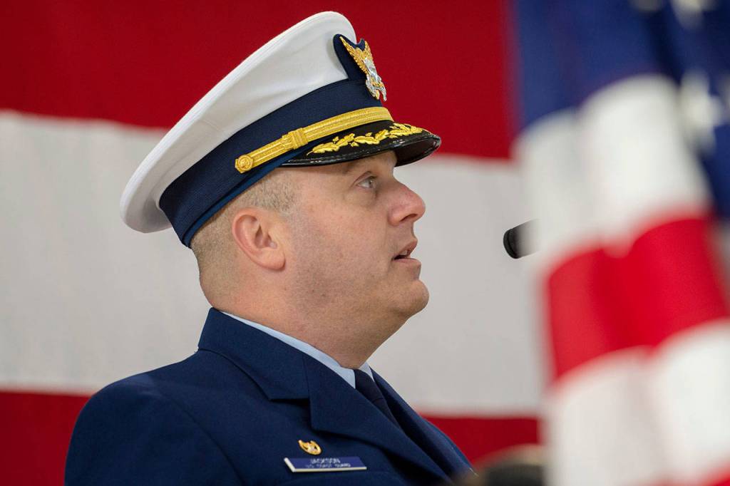 Cmdr. M. Scott Jackson of Coast Guard Air Station/Sector Field Office Port Angeles speaks about his familys history in the U.S. armed forces during the Veterans Day ceremony at the Coast Guard base Sunday. (Jesse Major/Peninsula Daily News)