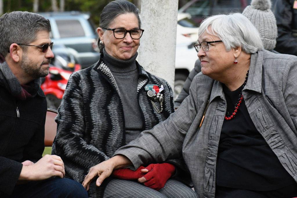 Clallam County Commissioner Mark Ozias and Jefferson County Commissioner Kathleen Kler speak with Joan Shields-Bennett at the memorial for her husband, U.S. Navy Petty Officer Marvin G. Shields, who died during the Vietnam War. (Jeannie McMacken/Peninsula Daily News)
