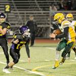 Michael Dashiell/Olympic Peninsula News Group Quilcenes Ben Bruner (14) pursues a Darrington runner during a Quad-District playoff game earlier this month.