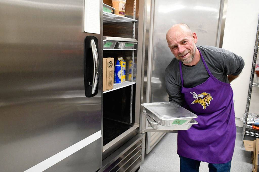 Volunteer cook John Voss led the food service at the Tri-Area Community Center in Chimacum. Over 250 traditional Thanksgiving meals were prepared for those eating at the center in addition to pre-ordered deliveries and take-out containers. (Jeannie McMacken/Peninsula Daily News)