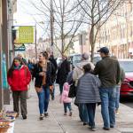Lee Chavez, left, in red jacket, from Whidbey Island and Maggie Goodall, from Seattle, walk down Water Street in Port Townsend after disembarking from the Coupeville ferry to do some shopping at local businesses during Small Business Saturday. (Steve Mullensky/for Peninsula Daily News)