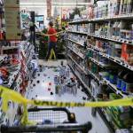 An employee walks past a damaged aisle at Anchorage True Value hardware store after an earthquake, Friday morning in Anchorage, Alaska. (Dan Joling/The Associated Press)