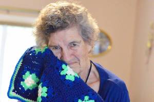(Diane Urbani de la Paz/for Peninsula Daily News)                                Marie Sewell of Port Townsend makes afghans  such as this one with Seahawks colors  to give away.