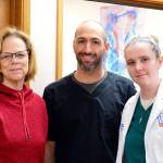 VIMO Executive Director Mary Hogan, left, works with volunteer Dr. Joe Churchill and Dental Clinic Manager Mischa Levis. (Diane Urbani de la Paz/for Peninsula Daily News)