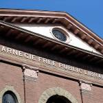 In this photo taken Oct. 10 the Carnegie name remains on what was the first major branch of the Seattle public library system, built with funds from philanthropist Andrew Carnegie. In service until 1963, the building now houses a variety of private enterprises. (Elaine Thompson/The Associated Press)