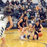 Lonnie Archibald/for Peninsula Daily News Neah Bays Ruth Moss (left) and Laila Greene compete with Forks Rylee Bouchard for control of the ball during the Red Devils 54-29 win over the Spartans on Wednesday.