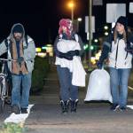 Mike Hollingsworth, Amy Miller, center, and Shenna Younger, right, walk towards the Salvation Army on Wednesday evening. (Jesse Major/Peninsula Daily News)