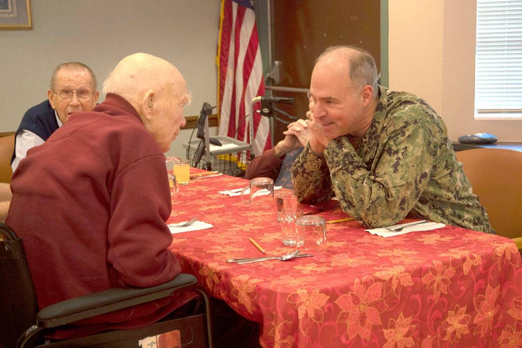 Rear Admiral Scott Gray, commander, Navy Region Northwest, talks with Roy Carter, a Navy veteran and survivor of Pearl Harbor, during a lunch with veterans at the Sherwood Assisted Living facility. (Mass Communication Specialist 2nd Class Wyatt L. Anthony/U.S. Navy)