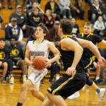 Michael Dashiell/Olympic Peninsula News Group Sequims Joey Oliver eyes the rim before putting up a layup attempt while defended by Forks Braton Armas during the Wolves 72-70 win.