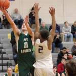 Mark Krulish/Kitsap News Group Port Angeles Kyle Benedict goes up for a layup while defended by North Kitsaps Kobe McMillian. Benedict led the Riders with 14 points in a 58-54 loss to the Vikings.