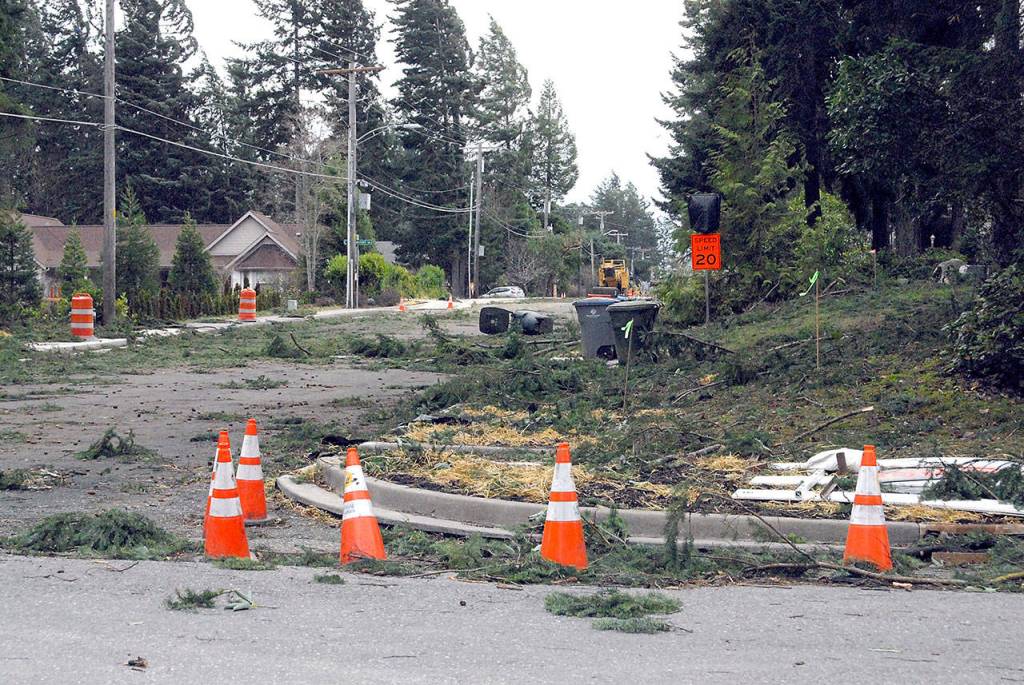 Tree branches and toppled trash containers litter the area at West 10th and N streets in Port Angeles on Friday. (Keith Thorpe/Peninsula Daily News)
