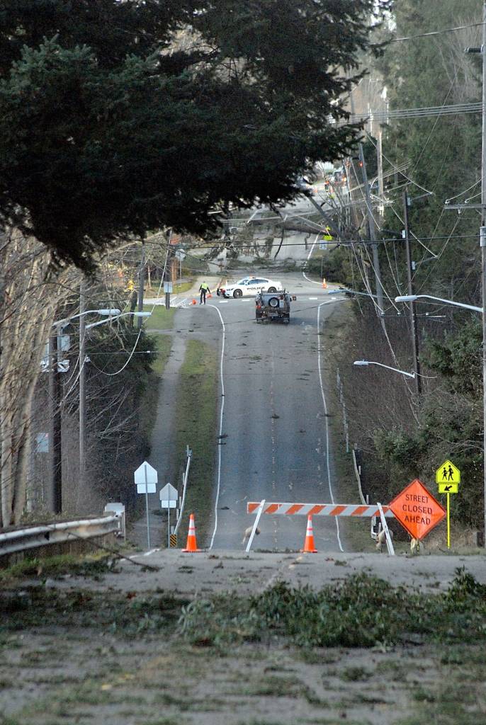 A barricade blocks a section of Park Avenue between Race and the Olympic National Park headquarters in Port Angeles after high winds drove trees into powerlines on Friday. (Keith Thorpe/Peninsula Daily News)