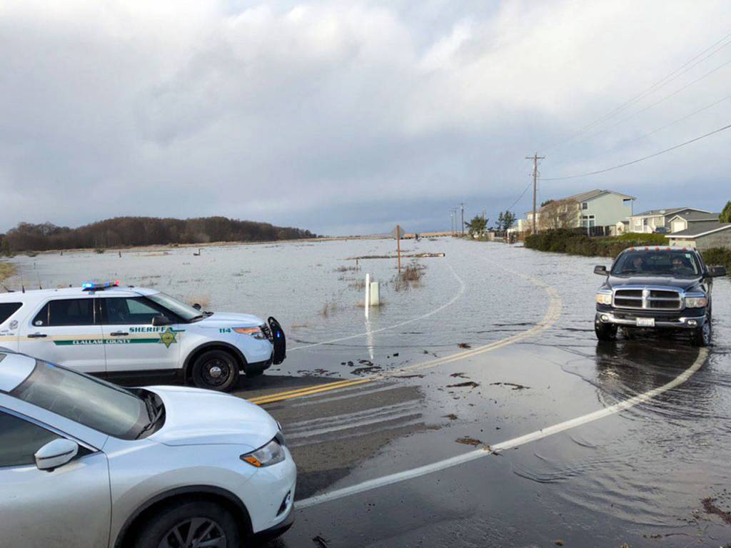 Units from the Clallam County Sheriffs Office and Clallam Fire District No. 3 help residents on a flooded 3 Crabs Road.