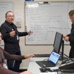 Jefferson County Emergency Management kept current with all issues in the county during the storm Thursday. They were tracking problems from power outages to road blockages and wind damage. Incident Management Team (IMT) volunteer Mark Miller, left, John Crooks, Emergency Operations Center supervisor and Ted Krysinski, IMT fire representative hold a briefing on the latest issues. (Jeannie McMacken/Peninsula Daily News)