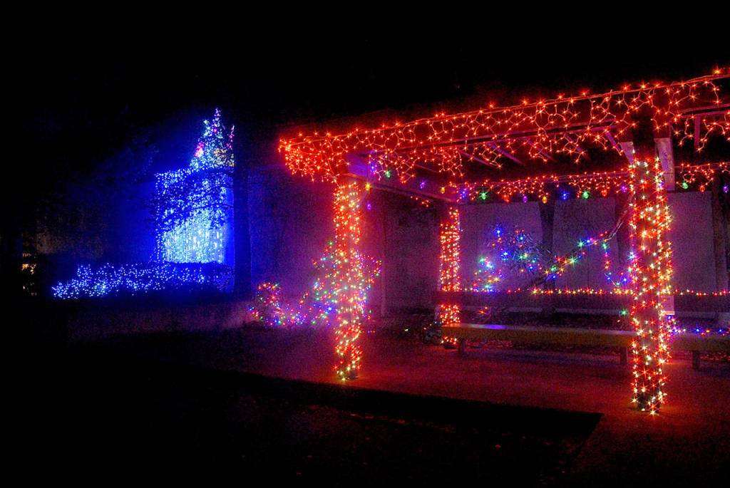 The gazebo at Washington Street and Sequim Avenue in downtown Sequim glows red for the holidays while a blue waterfall of lights is displayed on a nearby building. (Keith Thorpe/Peninsula Daily News)