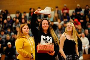 Samantha White shows her new kicks she received from one of Sonja Millers classes as a gift to the crowd during the Winter Wishes assembly. White said the shoes were fresh. (Matthew Nash /Olympic Peninsula News Group)