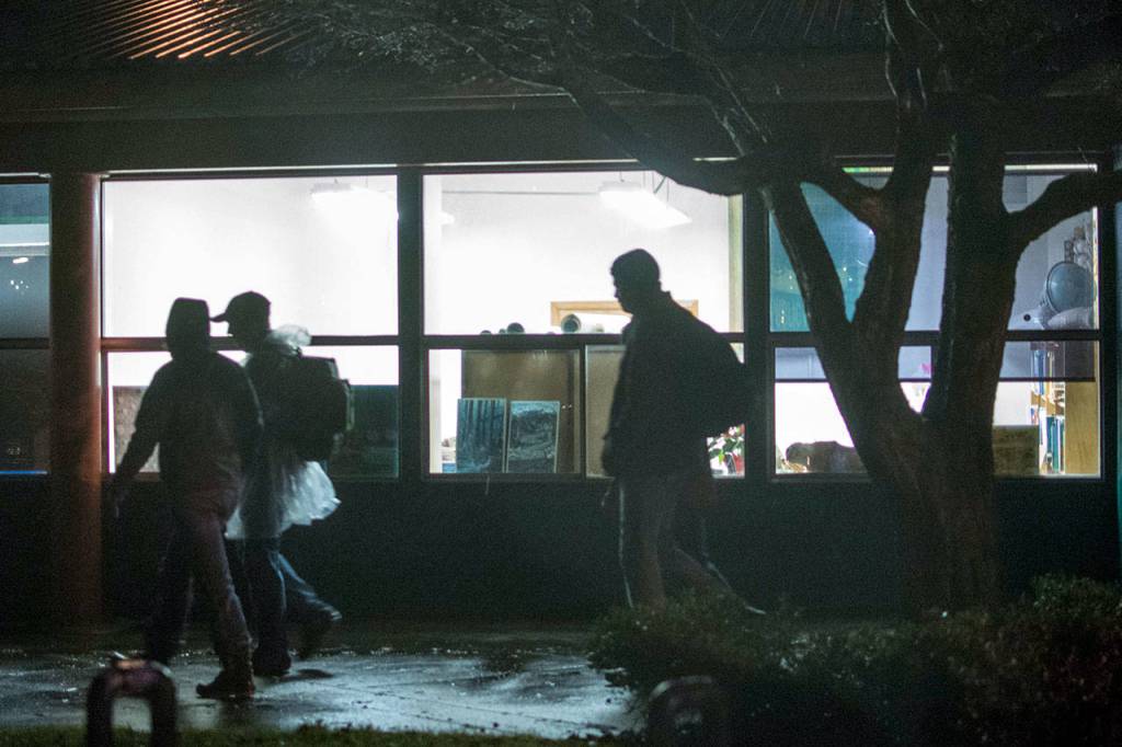 Clallam County Prosecuting Attorney Mark Nichols, Clallam County Commiissioner Mark Ozias, Amy Miller and Shenna Younger walk toward the Port Angeles City Pier Thursday evening. Nichols and Ozias stayed overnight at Serenity House of Clallam Countys night-by-night shelter. (Jesse Major/Peninsula Daily News)