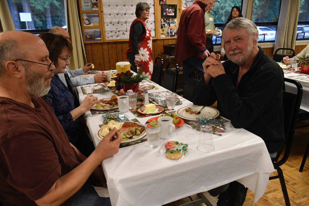 John Estes of Port Townsend enjoyed his meal at the Tri-Area Community Center in Chimacum on Christmas Day. He said one of the benefits, besides the good food, was sharing a meal with nice people he didnt know. Bret and Heidi Clark from Hansville joined Estes at the table. (Jeannie McMacken/Peninsula Daily News)