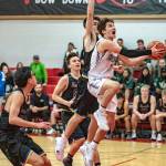 Steve Mullensky/for Peninsula Daily News Sequims Nate Despain drives to the basket against 3A Ferndale. The Wolves gutted out a 61-59 win with Despain scoring 14 points and dishing out eight assists. Riley Cowan scored 27 for the Wolves.