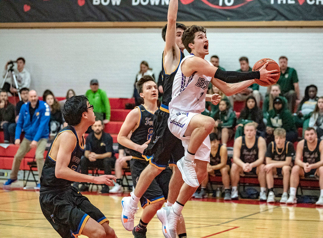 Steve Mullensky/for Peninsula Daily News Sequims Nate Despain drives to the basket against 3A Ferndale. The Wolves gutted out a 61-59 win with Despain scoring 14 points and dishing out eight assists. Riley Cowan scored 27 for the Wolves.