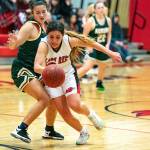 Steve Mullensky/for Peninsula Daily News Neah Bays Courtney Swan blasts past Auburns Jacklynn Smith and charges for the basket during a Crush in the Slush game in Port Townsend on Friday. Swan led the Red Devils with 19 points.