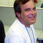 In this 2013 photo provided by Susan E. Madsen, Alan Naiman poses for a photo at his work at Childrens Administration (DSHS) Child Protective Services in Seattle. (Susan E. Madsen via AP)