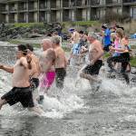 Polar bear plungers race into the frigid waters of Port Angeles Harbor at Hollywood Beach on New Years Day in Port Angeles. (Keith Thorpe/Peninsula Daily News)