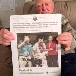 Roy Carter of Sequim holds a copy of the Honolulu Star-Advertiser with a front page photo of him and another veteran of the attack on Pearl Harbor in 2017, soon after the 75th anniversary of the attacks. Carter died on Jan. 3 at age 98. (Mary Powell/file)