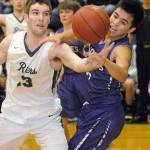 Keith Thorpe/Peninsula Daily News Port Angeles Garrett Edwards, right, fights for a rebound with Sequims Rigo Langston during the second quarter on Tuesday in Port Angeles.