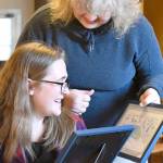 Marie Youssefirad surprised Amelia Rose Kauzlarich, 14, with a certificate and flowers for her winning design in the Type 2 Diabetes License Plate Design competition. Kauzlarich will also be awarded $200 this summer by the Fariborz Youssefirad Memorial Health Scholarship. (Jeannie McMacken/Peninsula Daily News)