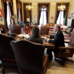 Gov. Jay Inslee, right, meets with staff members in his office as he goes over his State of the State speech Monday. Inslee is scheduled to deliver the annual address today. (Ted S. Warren/The Associated Press)