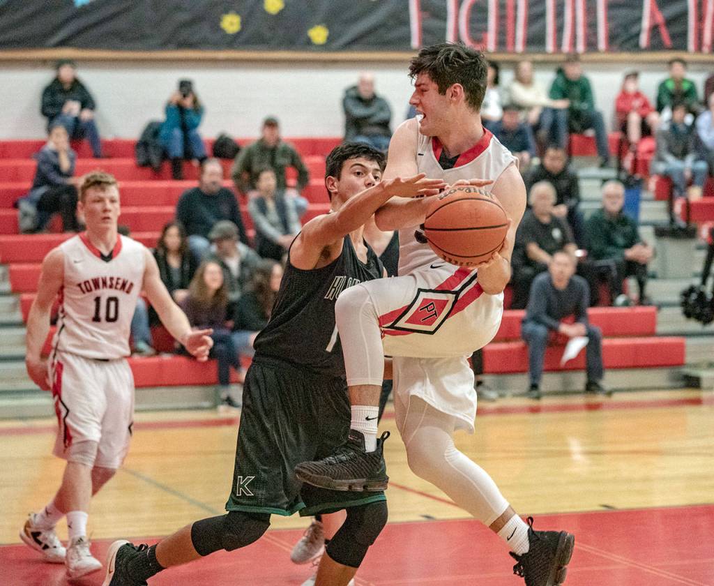 Steve Mullensky/for Peninsula Daily News Port Townsends Noa Montoya goes for two against the block of Klahowyas John Hartford during a Tuesday night game in Port Townsend.