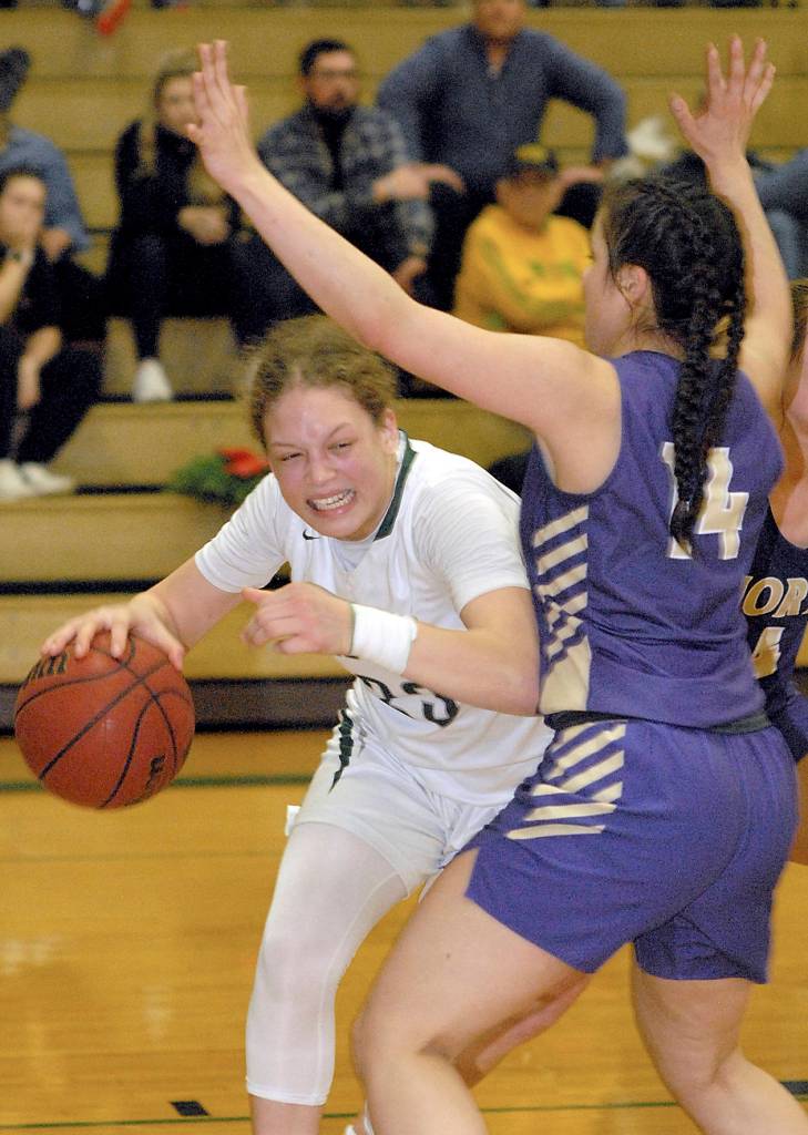 <strong>Keith Thorpe</strong>/Peninsula Daily News                                 Port Angeles Madison Cooke, left, slips around the defense of North Kitsaps Noelani Barreith during a game last month.