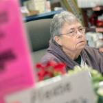 Mary Patterson, a volunteer at the Port Angles Food Bank, collects informaiton from federal workers during a special distribution for families of federal workers affected by the government shutdown. (Jesse Major/Peninsula Daily News)