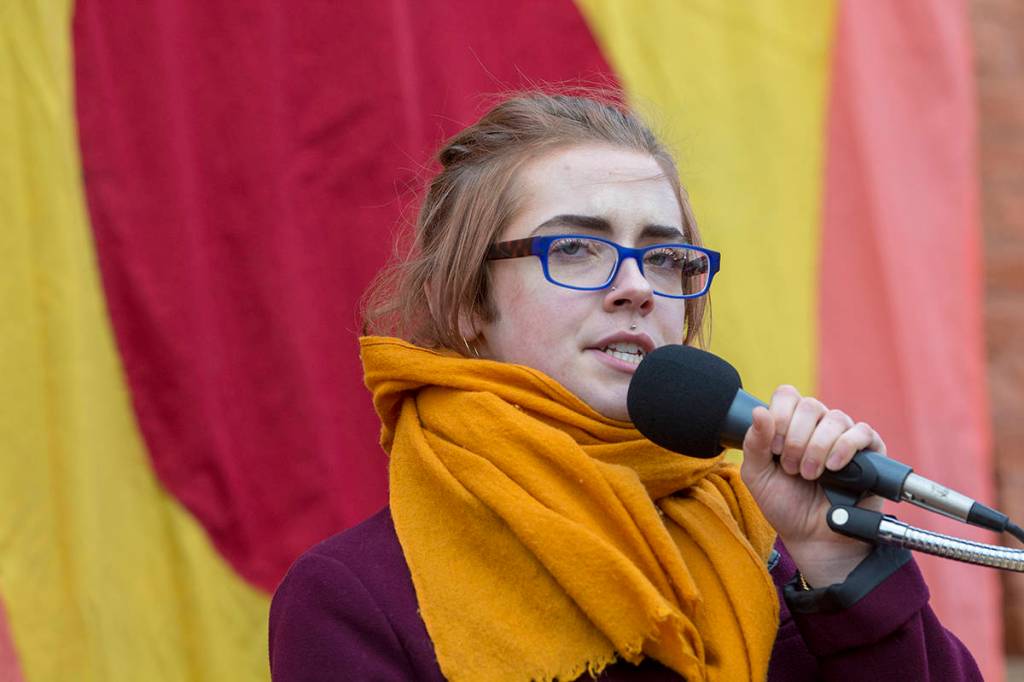 Eamon Redding of Port Townsend spoke about supporting the queer community during the third annual Olympic Peninsula Womxns Wave in Port Townsend on Sunday. (Jesse Major/Peninsula Daily News)