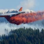 A tanker airplane drops fire retardant on a wildfire burning near Twisp. (Ted S. Warren/The Associated Press)
