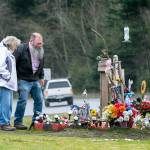 Debra and Gary Johnson on Tuesday visit the roadside memorial for their gandaughter, Brooke Bedinger, who died in a motorcycle wreck on U.S. Highway 101 at Morse Creek on June 21. (Jesse Major/Peninsula Daily News)