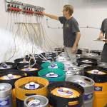 Discovery Bay Brewerys Patrick Raymond checks the regulator pressure while Glenn Jones takes keg inventory in preparation for their first appearance at Strange Brewfest this weekend in Port Townsend. The duo, along with 32 regional brewers and 5 cideries, will offer unusual concoctions not found anywhere else to 3,000 beer aficionados through Saturday night at the American Legion Hall. (Jeannie McMacken/Peninsula Daily News)